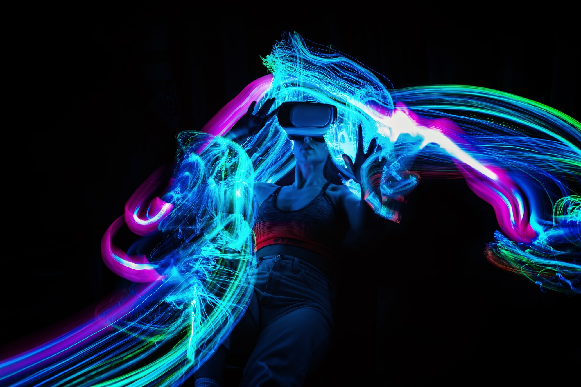 Metaverse. Woman in VR glasses playing AR augmented reality NFT game with neon blur lines